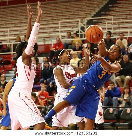 JAMAICA, NY-JAN 2: Delaware Blue Hens guard Jaquetta May (3) passes the ball around St. John\'s Red Storm during the first half at Carnesecca Arena on January 2, 2013 in Jamaica, Queens, New York.
