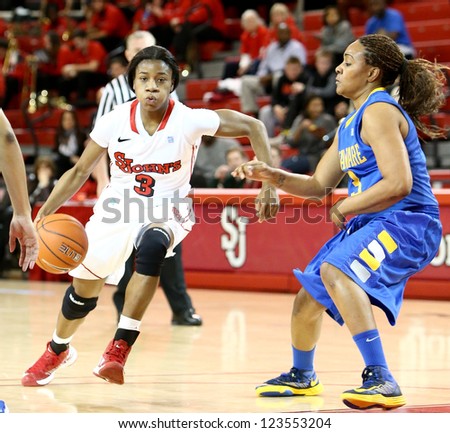 JAMAICA, NY-JAN 2: St. John\'s Red Storm guard Aliyyah Handford (3) dribbles around Delaware Blue Hens guard Jaquetta May (3) at Carnesecca Arena on January 2, 2013 in Jamaica, Queens, New York.