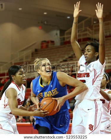 NEW YORK-JAN 2: Delaware Blue Hens guard Elena Delle Donne (11) shoots as St. John\'s Red Storm guard Shenneika Smith (35) defends at Carnesecca Arena on January 2, 2013 in Jamaica, New York.