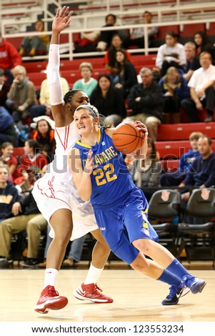 JAMAICA, NY-JAN 2: Delaware Blue Hens guard Lauren Carra (22) dribbles past St. John\'s Red Storm forward Amber Thompson (2) at Carnesecca Arena on January 2, 2013 in Jamaica, Queens, New York.