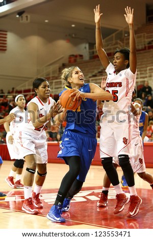 JAMAICA, NY-JAN 2: Delaware Blue Hens guard Elena Delle Donne (11) shoots as St. John\'s Red Storm guard Shenneika Smith (35) defends at Carnesecca Arena on January 2, 2013 in Jamaica, New York.