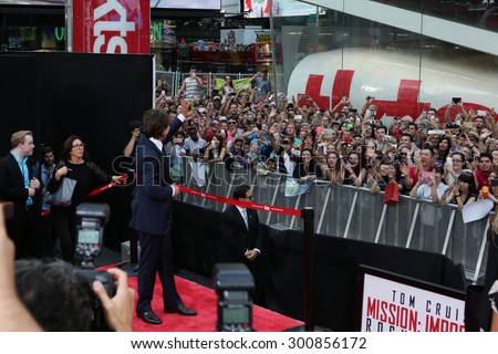 NEW YORK-JUL 27: Actor Tom Cruise waves to the crowd at the US Premiere of \'Mission: Impossible - Rogue Nation\' in Times Square on July 27, 2015 in New York City.