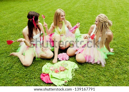 group of beautiful female friends smiling.  three pretty  girls