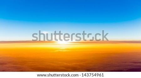 sunset above clouds. View of sunset  from airplane window