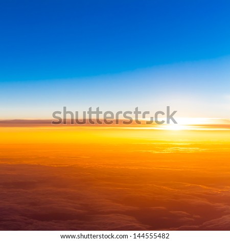 Sunset Above Clouds. View Of Sunset From Airplane Window