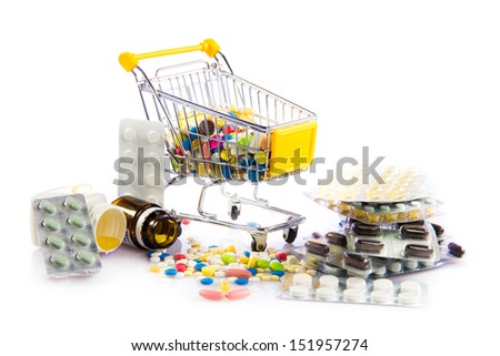 colorful tablets in the cart. Shopping cart with medicine pills on a white background