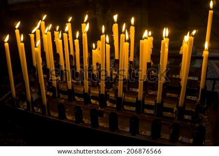 Church candle in a row.  Closeup of burning candle