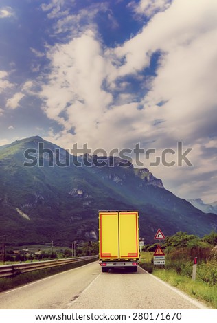 truck on the road.  Yellow cargo car