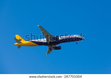 FARO, PORTUGAL - MAY 09 : Monarch Flights aeroplane lands at Faro International Airport, on May 09, 2015 in Faro, Portugal. Monarch is a British airline with 32 jet airliners
