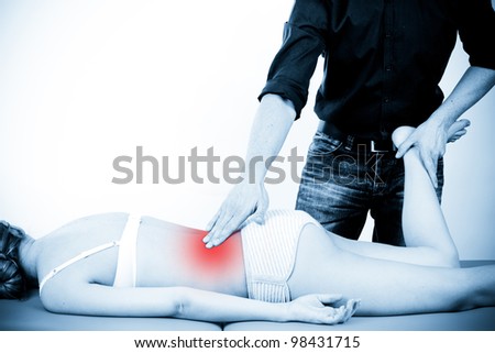 Massage therapist giving a massage. female receiving professional massage. pain concept.