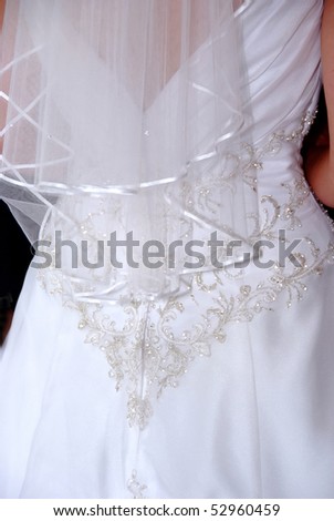 stock photo Close up of the bead work on a wedding dress from the back