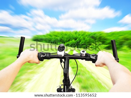 Man with bicycle riding on country road