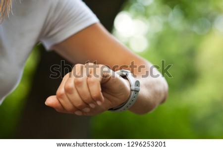 Woman is looking on her smart watches on her hand