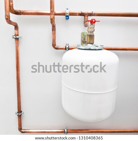 A lot of copper pipes in the boiler-room and expansion tank