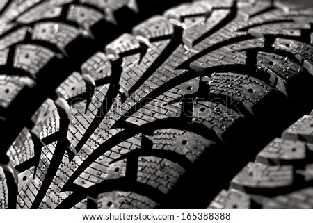 winter car tyre on a black background