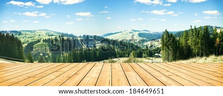 wooden terrace and panorama of early spring in the mountains. Carpathian, Ukraine, Europe
