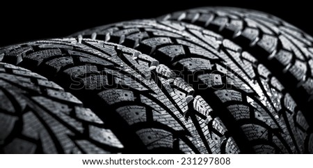 winter car tyre on a black background