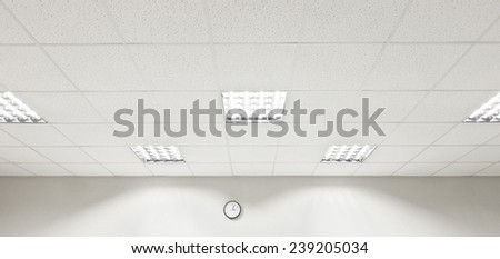 Fluorescent lamp on the modern ceiling and wall