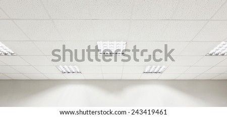 Fluorescent lamp on the modern ceiling and wall