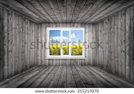 Wooden room in dark color and in center window with field inside