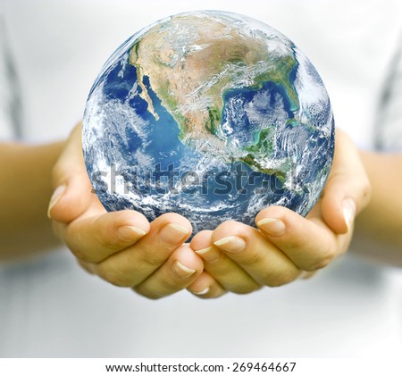 The open hands of woman and earth in. Elements of this image furnished by NASA