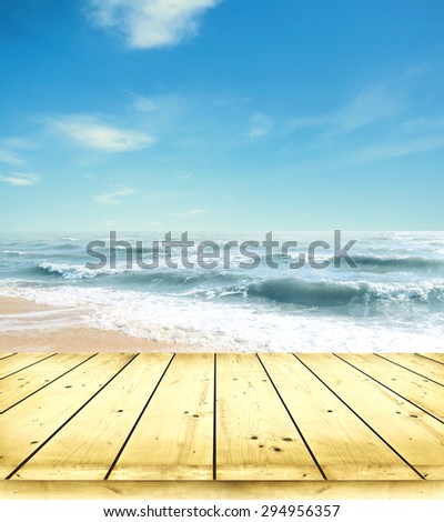 Yellow sand beach and blue sky and sea with wooden floor