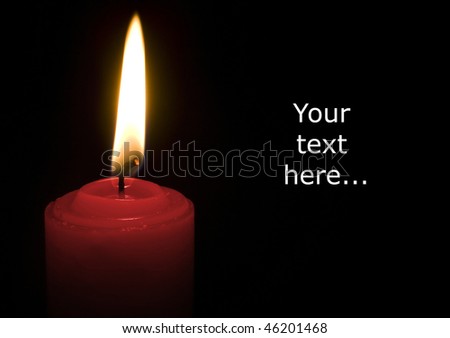 One burning red candle isolated on black background