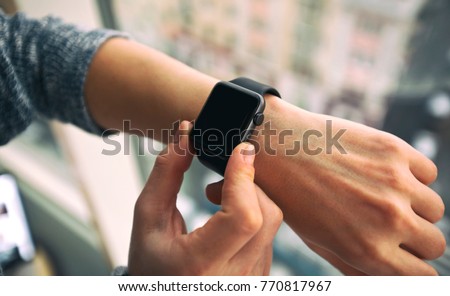 The modern smart watch on the woman\'s hand