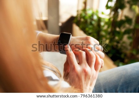 The modern smart watches on the woman\'s hand
