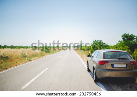 Back of car on a long and straight road in Croatia