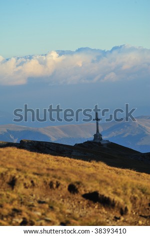 Vertical landscape with monument(Crucea Caraiman) Bucegi mountains, Romania