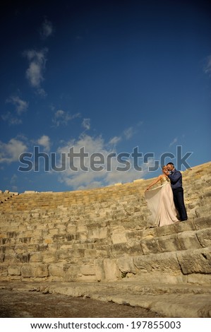 Passionate couple at a beautiful antique Roman amphitheater.