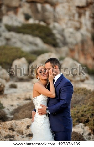 Portrait of beautiful wedding couple in beautiful rocky landscape.