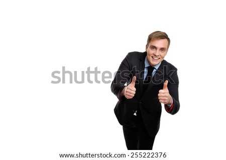 Yes! This proposal is the best. Young smiling and attractive businessman showing his thumbs up. Copy space on the left can be used for your text.