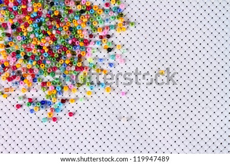 Color beads scattered on the fabric, close-up