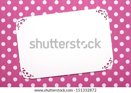 White lace frame on a pink spotty background