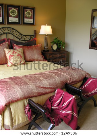 A photo of a luxurious bedroom (Focus at Base of Bed)