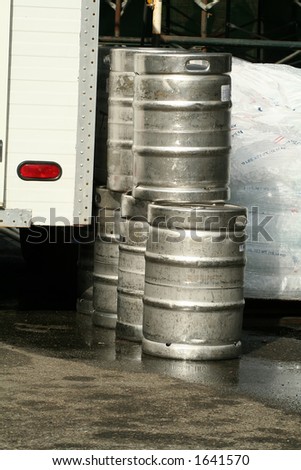 Kegs of beer unloaded from a truck and bags of ice