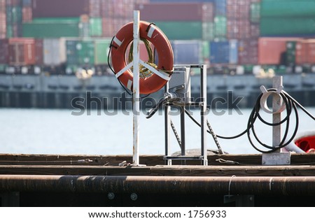 Life preserver on ship with cargo containers in the background (Focus on life preserver)