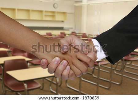 A student meeting the teacher in the classroom of a school