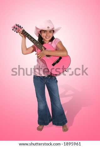 A cute girl in pink playing the guitar