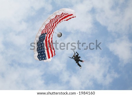 A man sky diving with a flag parachute