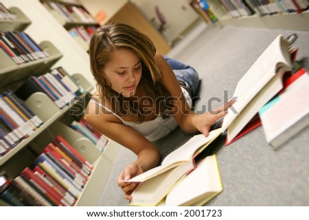 A young woman studying hard in the library