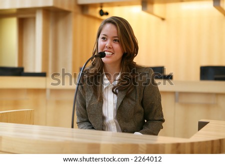 stock photo : A pretty young woman testifying in court