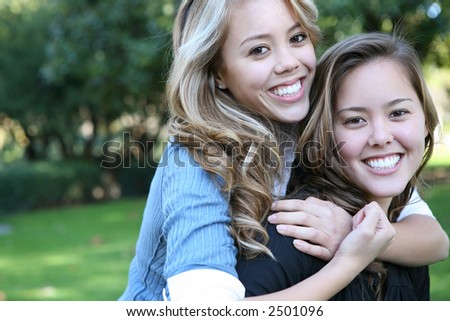 Two attractive sisters displaying the love of family