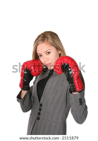 A business woman with boxing gloves ready to fight or do battle