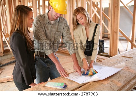 Two designers and a home builder discussing color plans