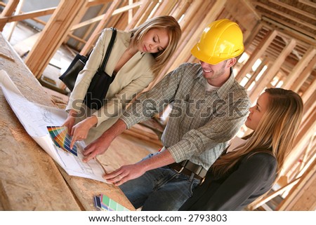 Two designers and a home builder discussing color plans