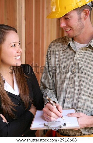 A man construction worker requesting the customer to sign a contract