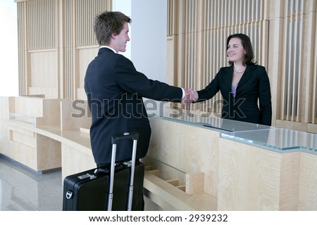 A business man arriving in the lobby for a sales meeting